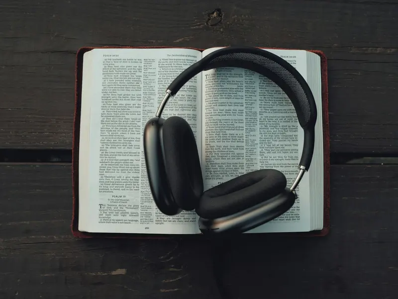 Headphones resting on an open book