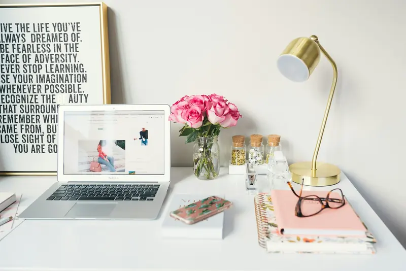Laptop on a bright desk showing an author website