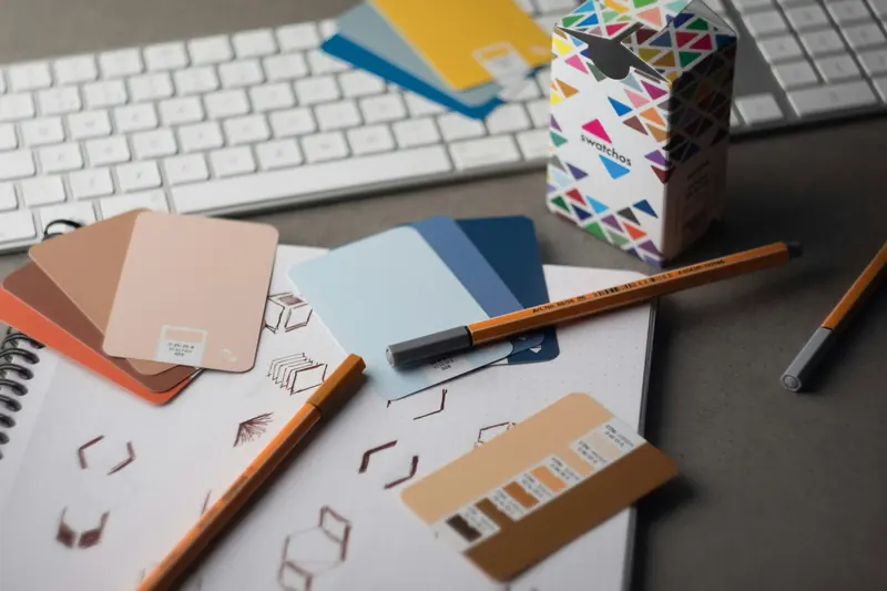 Designer desk with color swatches and cover sketches