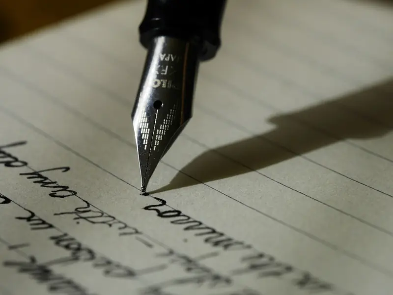 Fountain pen writing a manuscript on lined paper